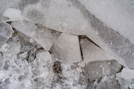 Broken ice on a walkway in winterの写真素材
