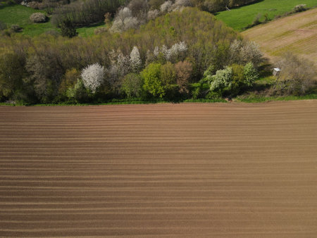 View from above of freshly plowed arable field with soil in the countrysideの写真素材