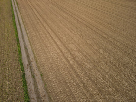 Plowed arable field with soil from above in springの写真素材