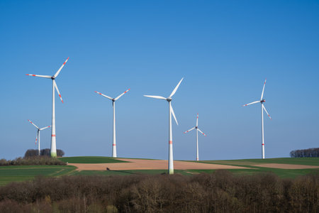 Wind turbines in the landscape on a sunny day with blue sky
