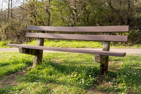 Wooden bench on the hill with a view of the landscape in blooming springの写真素材