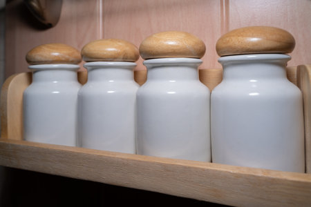 Ceramic salt and pepper shakers with wooden lidの写真素材