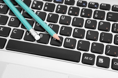 Two pencils on a keyboardの写真素材