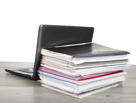 Many files and a computer on a desk isolated on white background