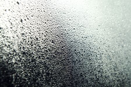 Water drops on a glass surface as backgroundの写真素材