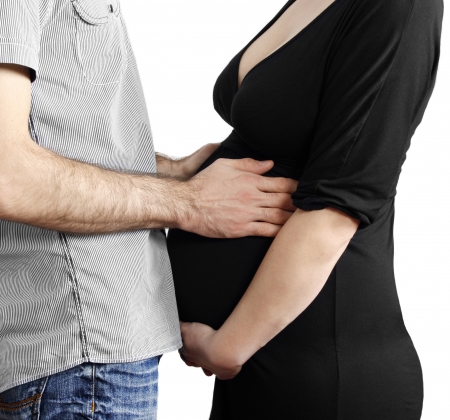 Mom and dad with hands on the bellyの写真素材