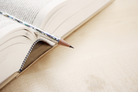 Open book and a pen on a desk