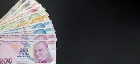 Turkish banknote (200-100 -50-20-10 Turkish Lira) stacked on black background, top view