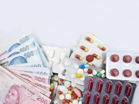 TL money pills isolated on black background. Medication costs. High costs of medicine concept. place...