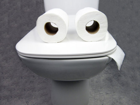 Toilet bowl with two rolls of paper similar to eyes or glasses. Funny concept of running out of toilet paperの写真素材