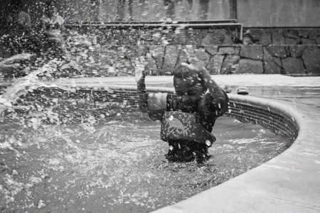 Portrait of a boy playing in a pool showing great happiness.の写真素材