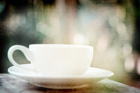 a white cup of black coffee in garden backgroundの写真素材