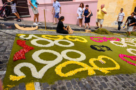 In this festival, carpets of flowers, sand and shrubs are woven and laid out in the streets near the town hall square.のeditorial素材