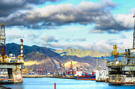 The port of Santa Cruz, ships, working platforms, the Anaga Mountains, dramatic clouds.の写真素材