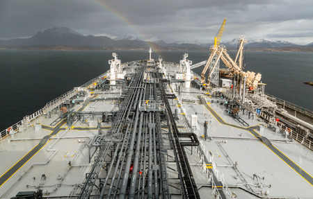 Oil product tanker moored to the jetty in Norway discharging the cargo to oil terminal.の写真素材