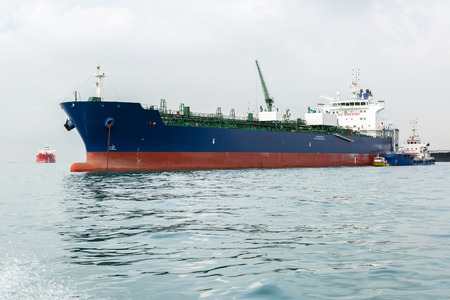 Blue and red ship in the sea while calm weather during bunkering operation.の写真素材