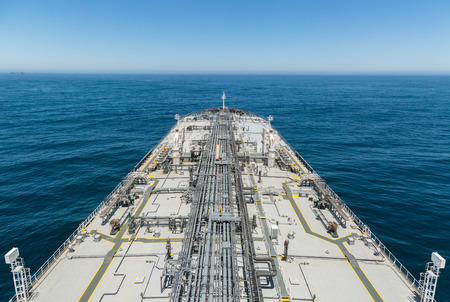 Grey crude tanker ship proceeding to skyline of the deep blue seaの写真素材