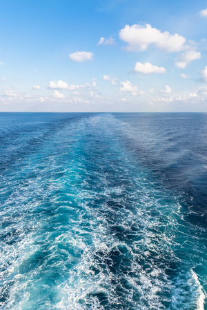 Wake of prop wash on blue ocean - verticalの写真素材