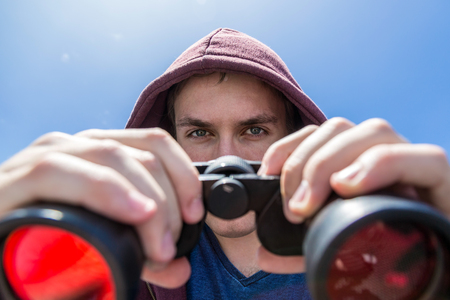 Man with red lens binocular.の写真素材