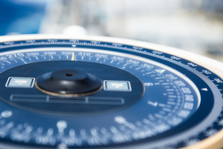 Compass aboard large ship on a blue summer sea.の写真素材