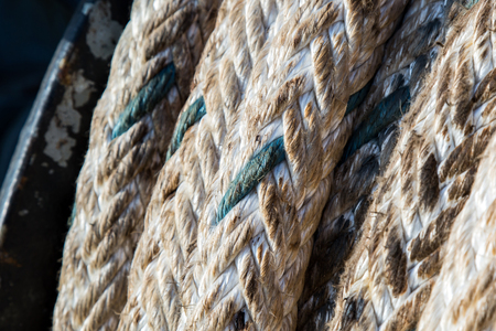 mooring winch mechanism with rope on forward of ship deck on blue sky backgroundの写真素材
