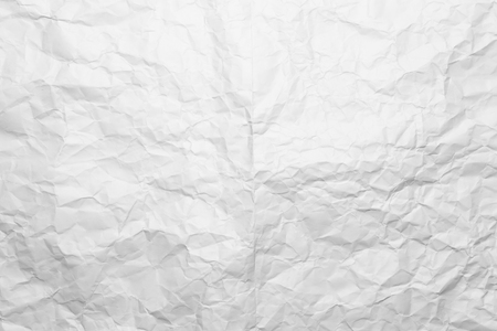 Background of a crumpled white sheet of a paper.の写真素材