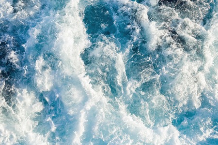 Aerial view to ocean waves. Blue water background.の写真素材