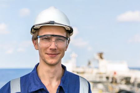 Portrait of a young european engineer in a helmet and safety goggles.の写真素材
