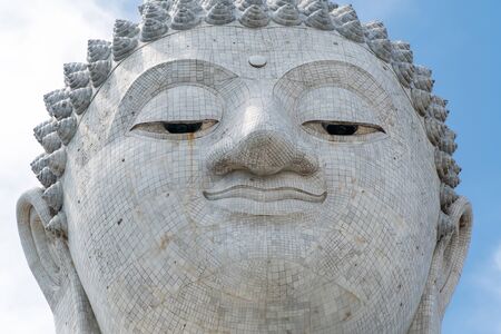 closeup view of big buddha monument face in thailandの写真素材