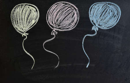 three air multicolored balloons drawn with chalk on a black board. Copy spaceの写真素材
