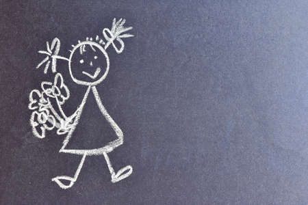 Chalk drawing, girl with bouquets of flowers drawn in chalk on a black board. copy space