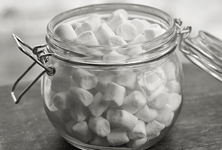white and pink marshmallows in a glass jar. sweetsの写真素材