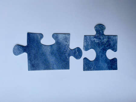 jigsaw puzzle teamwork concept disassembled on blue backgroundの写真素材