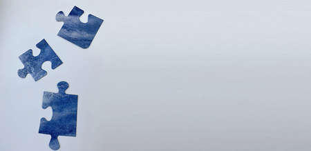 jigsaw puzzle teamwork concept disassembled on blue background bannerの写真素材