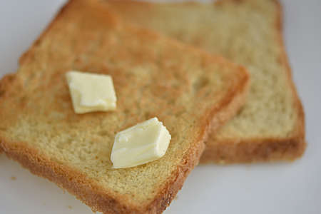 toasted bread with pieces of butter. breakfast. food on the toasterの写真素材