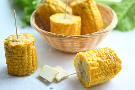 boiled corn on wooden sticks with butter. inscription diet. Vegetarian food. Diet. healthy eatingの写真素材