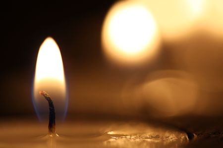 Candle burning with black background in shallow depth of fieldの素材 [FY3104970177]