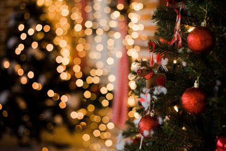 Christmas decorations, tree with lights and toys. Festive atmosphere at home during Christmas. New Year tree and lightsの写真素材