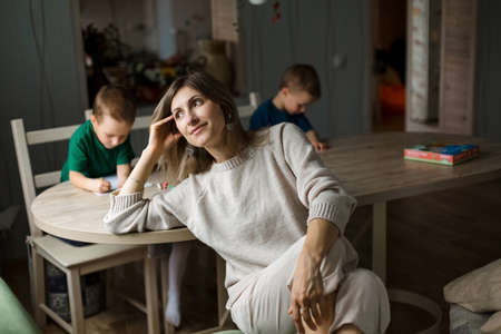 brooding mother with children, children are busy with self-development. Happy family.