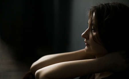 Girl close-up in profile portrait silhouette. Side space.