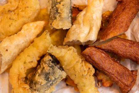 Close up of fried fish and chips on baking paper. Selective focus.の写真素材
