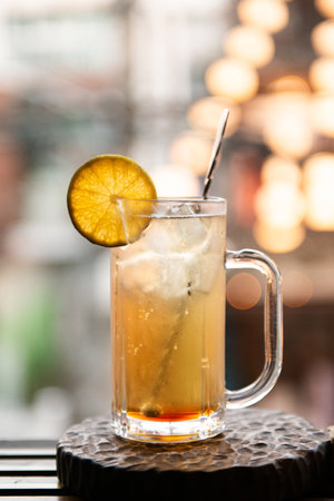 Iced tea with lemon in a glass on a wooden table.の写真素材
