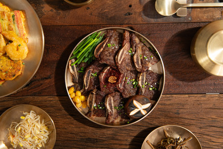 beef tenderloin with potatoes and chives on wooden tableの写真素材