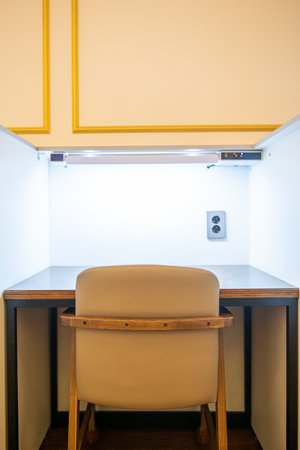 Interior of a hotel room with reception desk, chairs and door
