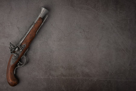 Antique gun on grunge background. Copy space for text.