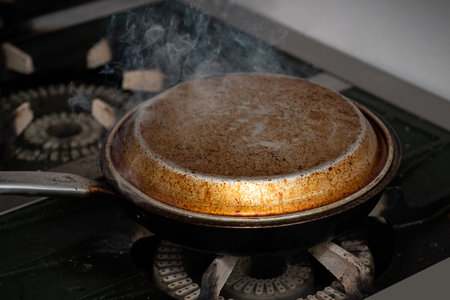 Cooking in a frying pan on a gas stove. Selective focus.