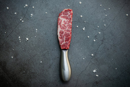 Sliced wagyu beef meat on a butcher's knifeの写真素材