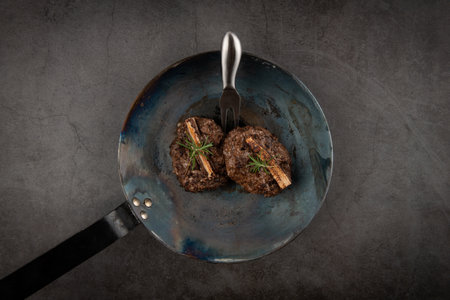 Grilled meatballs with rosemary in a pan on a dark backgroundの写真素材