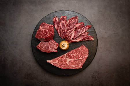 Sliced raw beef steak on black stone background. Top viewの写真素材