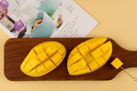 Mango fruit on a wooden cutting board. Tropical fruit concept.